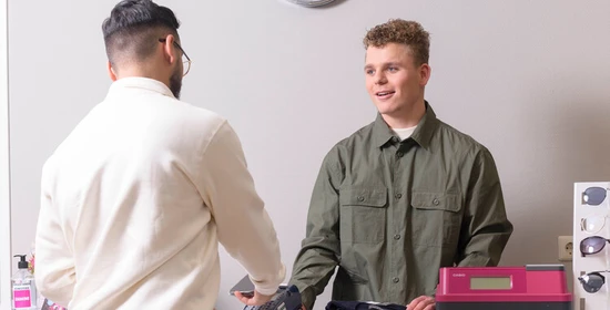 Retail medewerker werkt aan de kassa